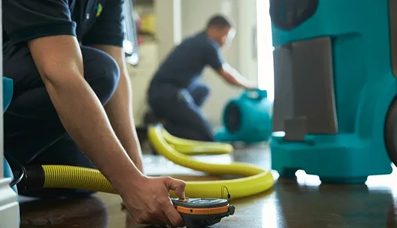 Image of emergency water extraction equipment in use, emphasizing the step-by-step process for effective water damage cleanup and restoration services.